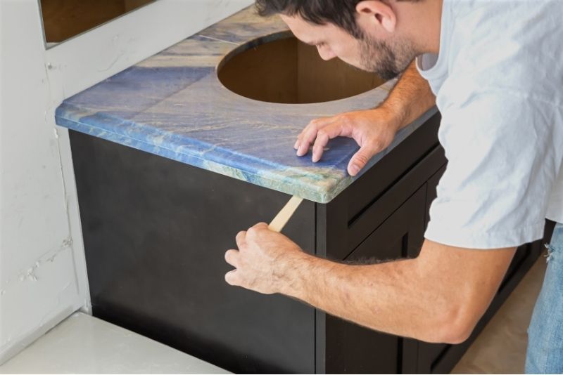 a man fixing a huge bathroom vanity in Newcastle