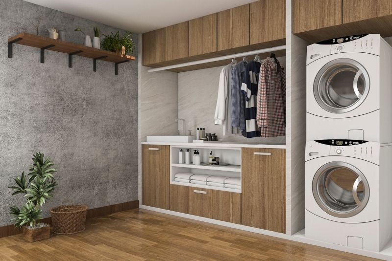 laundry space with 2 washing machine and indoor plants