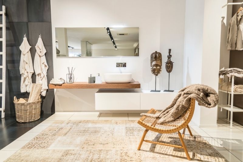 bathroom design with carpet on the floor and a chair with towel
