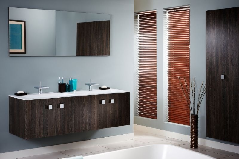 minimalist design bathroom makeover with brown cabinet matching the door color