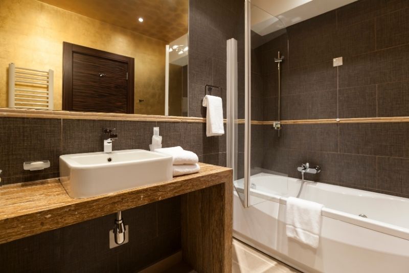 luxury bathroom renovation with large mirror reflecting the wall