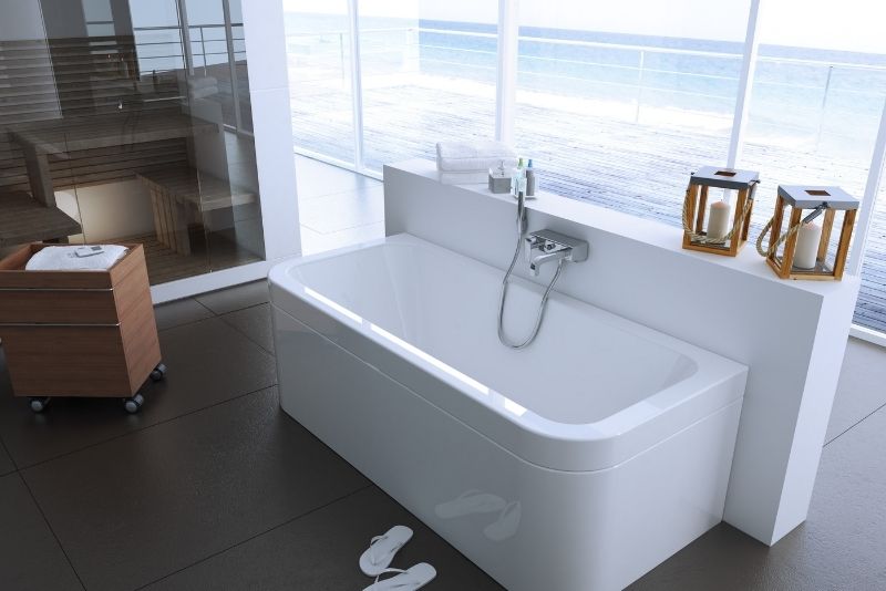 white bath tub with the ocean bathroom