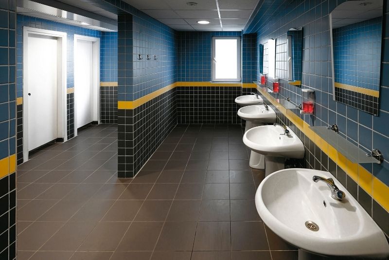 commercial bathroom in Newcastle with 4 toilet sink