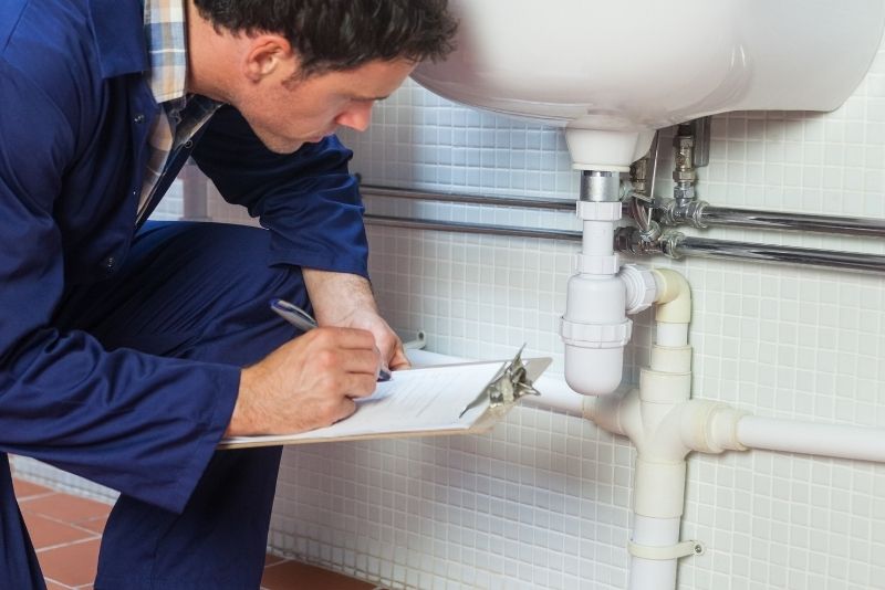 bathroom expert checking the inspecting the bathroom plumbing