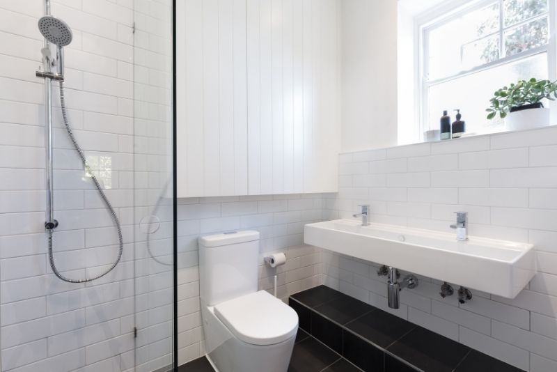 clean looking bathroom area in a white wall and crystal shower