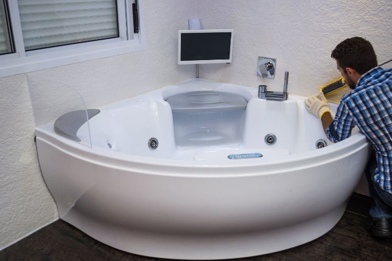 bathroom expert doing a bathroom tub installation