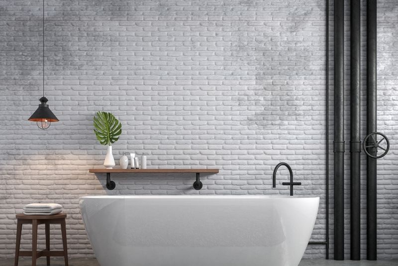 large bath tub beside the white wall