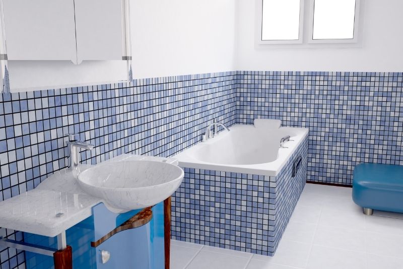 blue small patterned bathroom tiles in the wall and on the bath tub