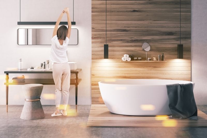 a girl stretching in a newly renovated bathroom