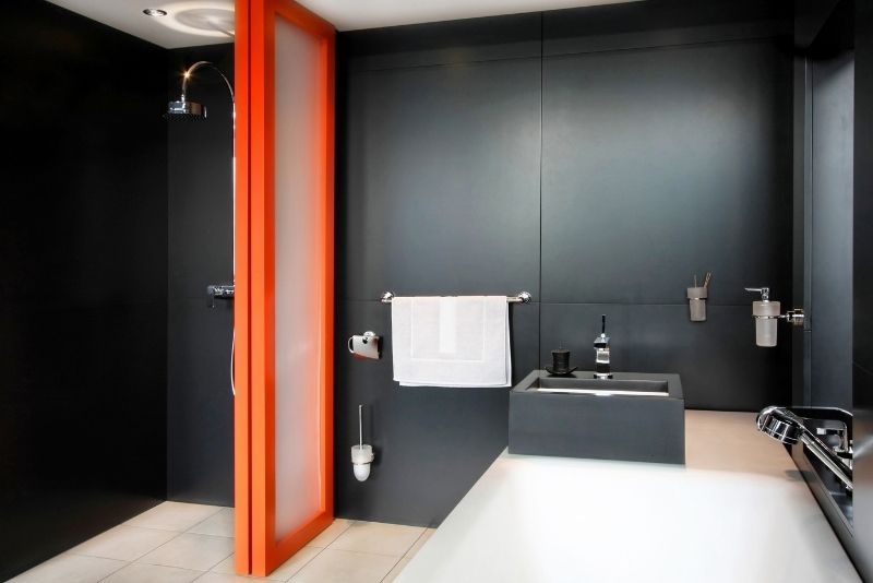 bathroom designs having full black wall tiles